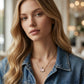 Model in a denim jacket wearing the light pink stone Kendra Scott rabbit pendant necklace.