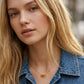 Blonde female model wearing the gold-tone Samantha Sunburst short pendant necklace with a denim jacket.
