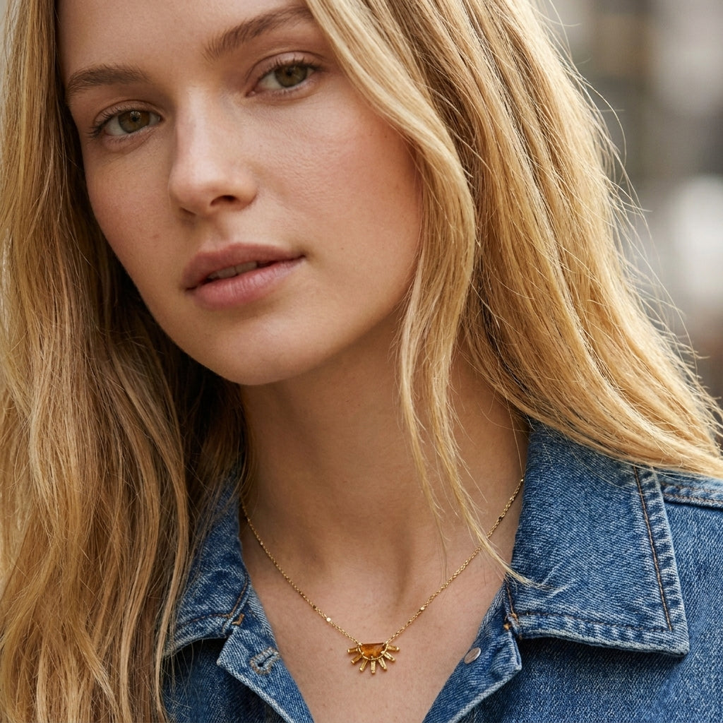 Blonde female model wearing the gold-tone Samantha Sunburst short pendant necklace with a denim jacket.