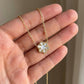 Hand-held size reference of the Kendra Scott Snowflake Necklace for delicate scale