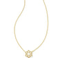 Macro detail of the gold snowflake pendant showing intricate cutouts and crystals