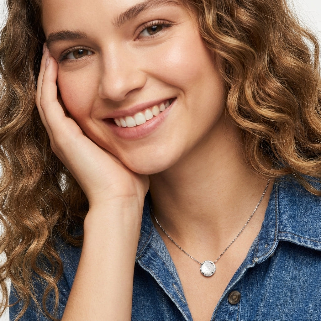 Smiling female model with curly hair showcasing the white mother of pearl short pendant necklace