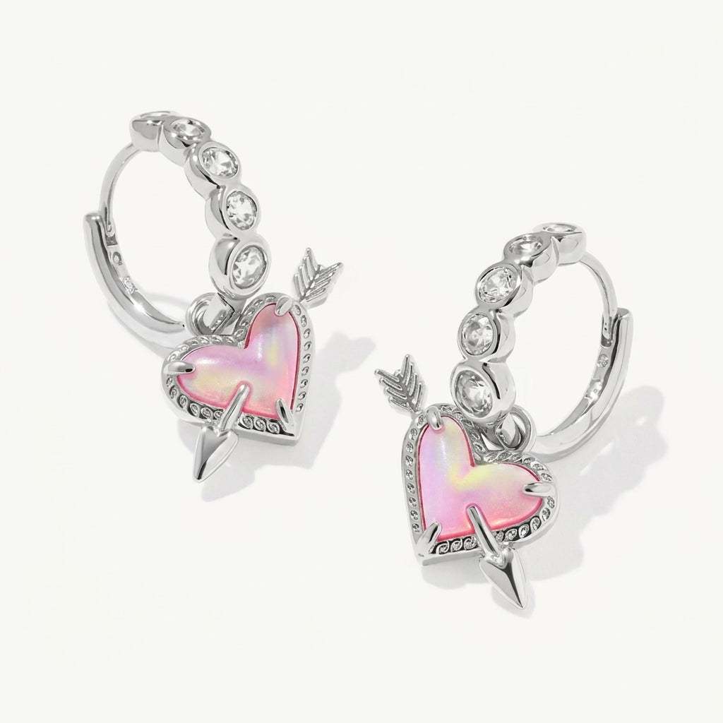 Silver hoop earrings with pink heart and arrow design on a white background