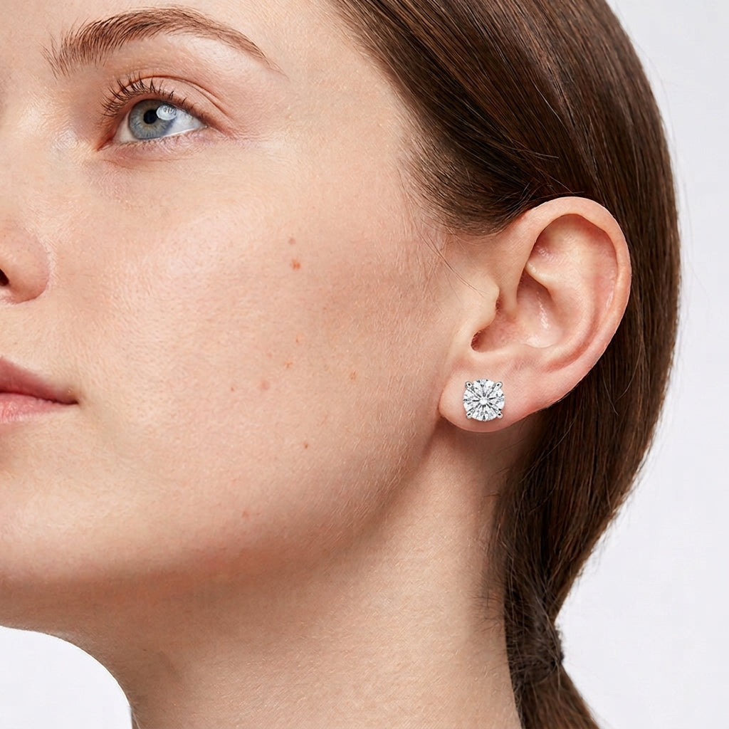 Model wearing lab grown diamond snowflake heart prong stud earrings.