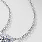 Close-up view of delicate silver cable chain attached to cushion halo lab diamond pendant.