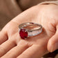 Silver ring with a red gemstone on a hand