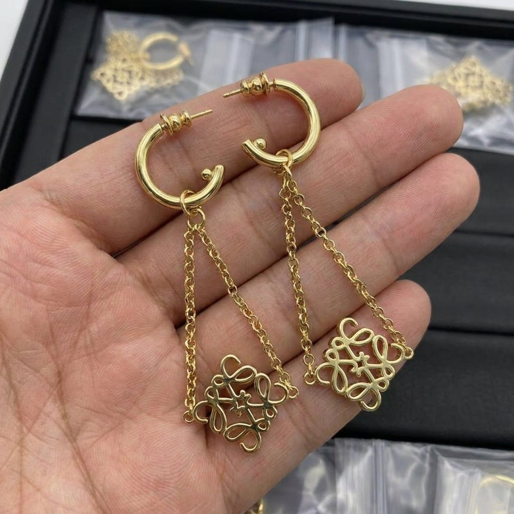 Hand-held size reference of the Loewe Gold Drop Earrings to show the pendant length