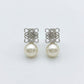 Loewe Anagram Geometric Pearl Earrings featuring an openwork logo and natural pearl drop