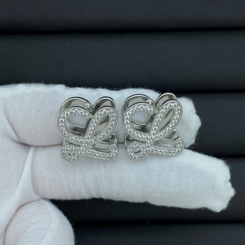 Hand-held size reference of the Loewe Anagram Geometric Earrings for true scale
