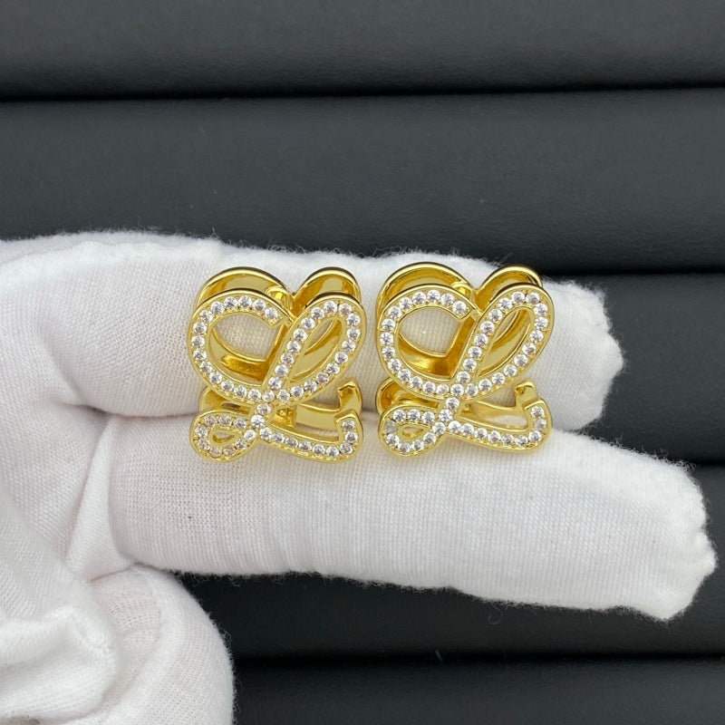 Hand-held size reference of the Loewe Anagram Geometric Earrings for true scale