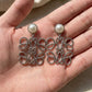 Hand-held size reference of the Loewe Silver Pearl Earrings to show the true pendant scale