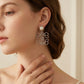 Side view of model wearing Loewe Silver Pearl Drop Earrings, elegant accessory for daily luxury