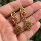 Hand-held size reference of the Loewe Gold Pendant Earrings to show the true drop length