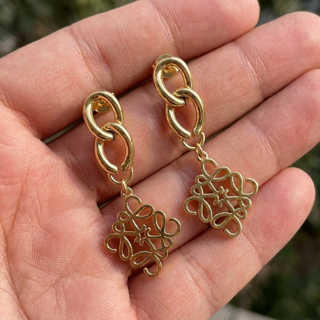 Hand-held size reference of the Loewe Gold Pendant Earrings to show the true drop length
