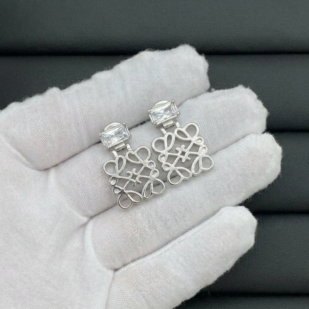 Hand-held size reference of the Loewe Cutout Crystal Earrings to show the luxurious scale
