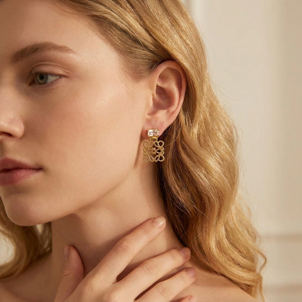 Model wearing Loewe gold Cutout Crystal Earrings, a bold statement piece for evening luxury