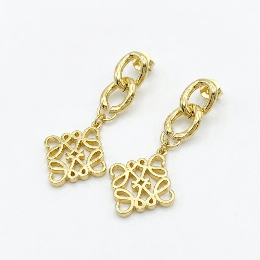 Macro detail of the Loewe Anagram pendant earrings showing the precision polished edges