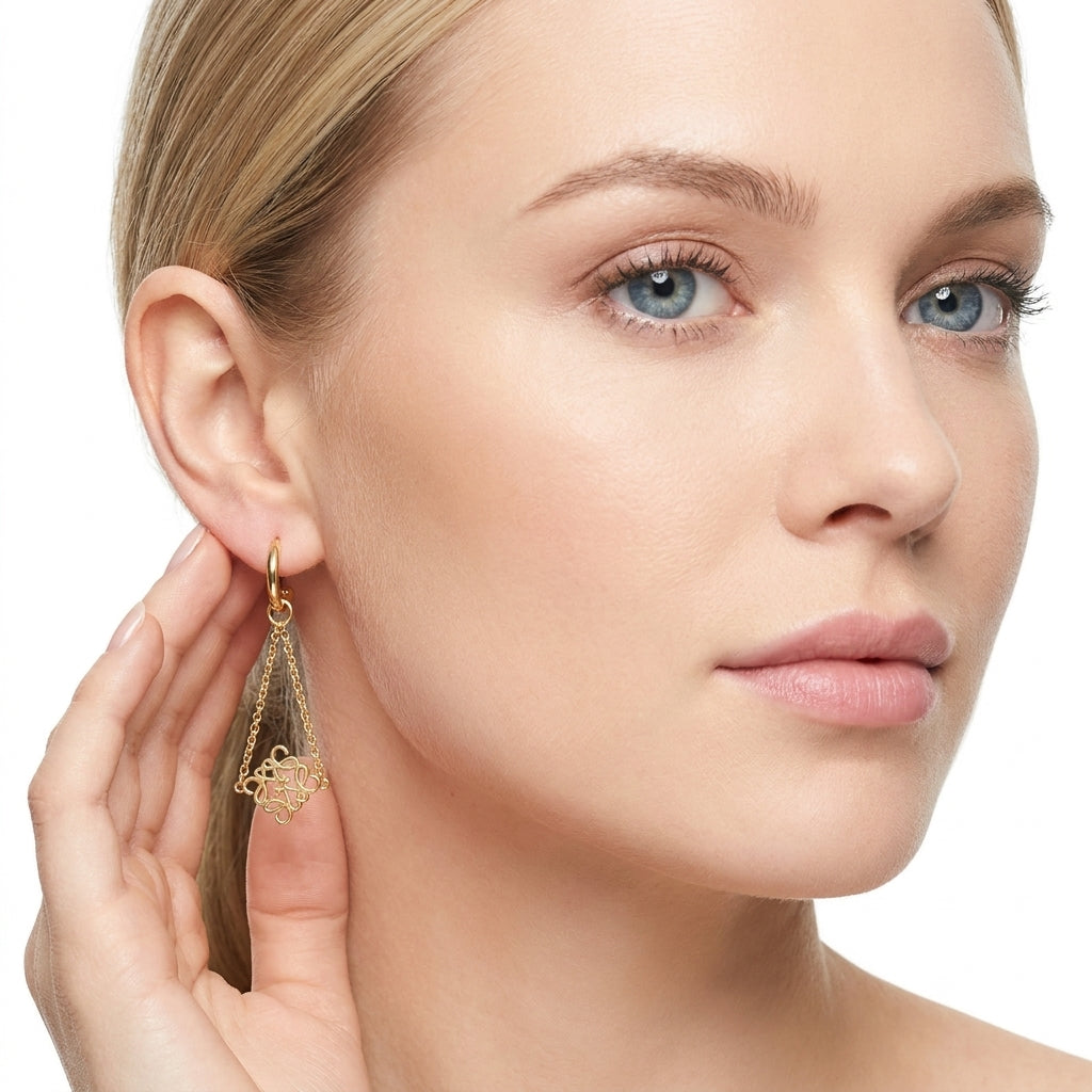 Model wearing Loewe Anagram Gold Drop Earrings, a sophisticated statement for daily luxury