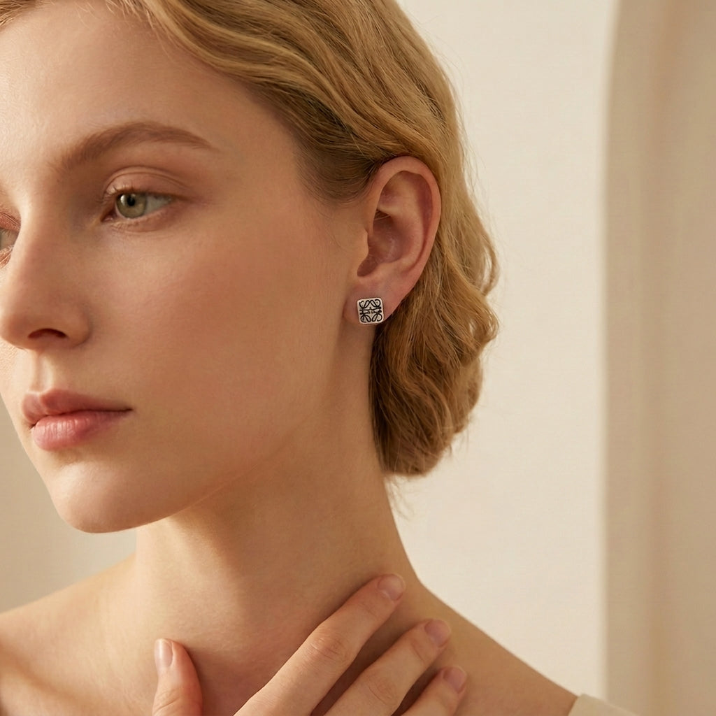 Model wearing Loewe Silver Anagram Square Studs, a chic minimalist statement for daily luxury