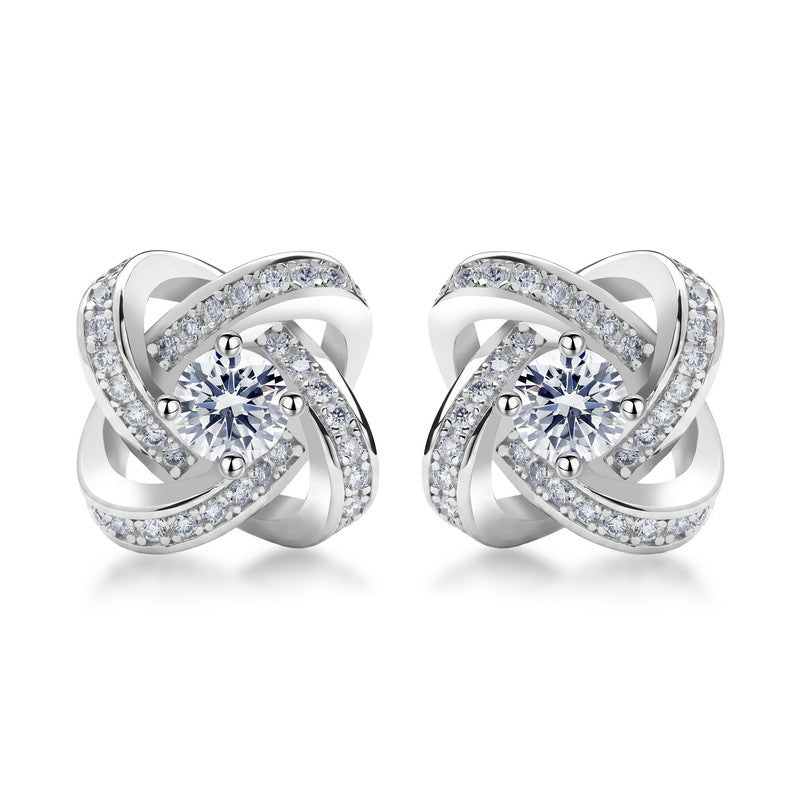 Love knot round cut lab grown diamond pavé halo stud earrings in 925 sterling silver.