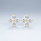 Studio macro display highlighting four heart cut moissanite stones set in golden clover frame.