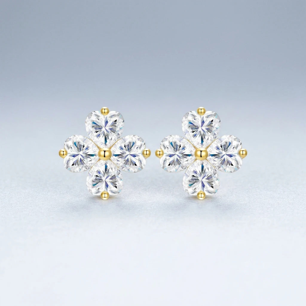 Studio macro display highlighting four heart cut moissanite stones set in golden clover frame.