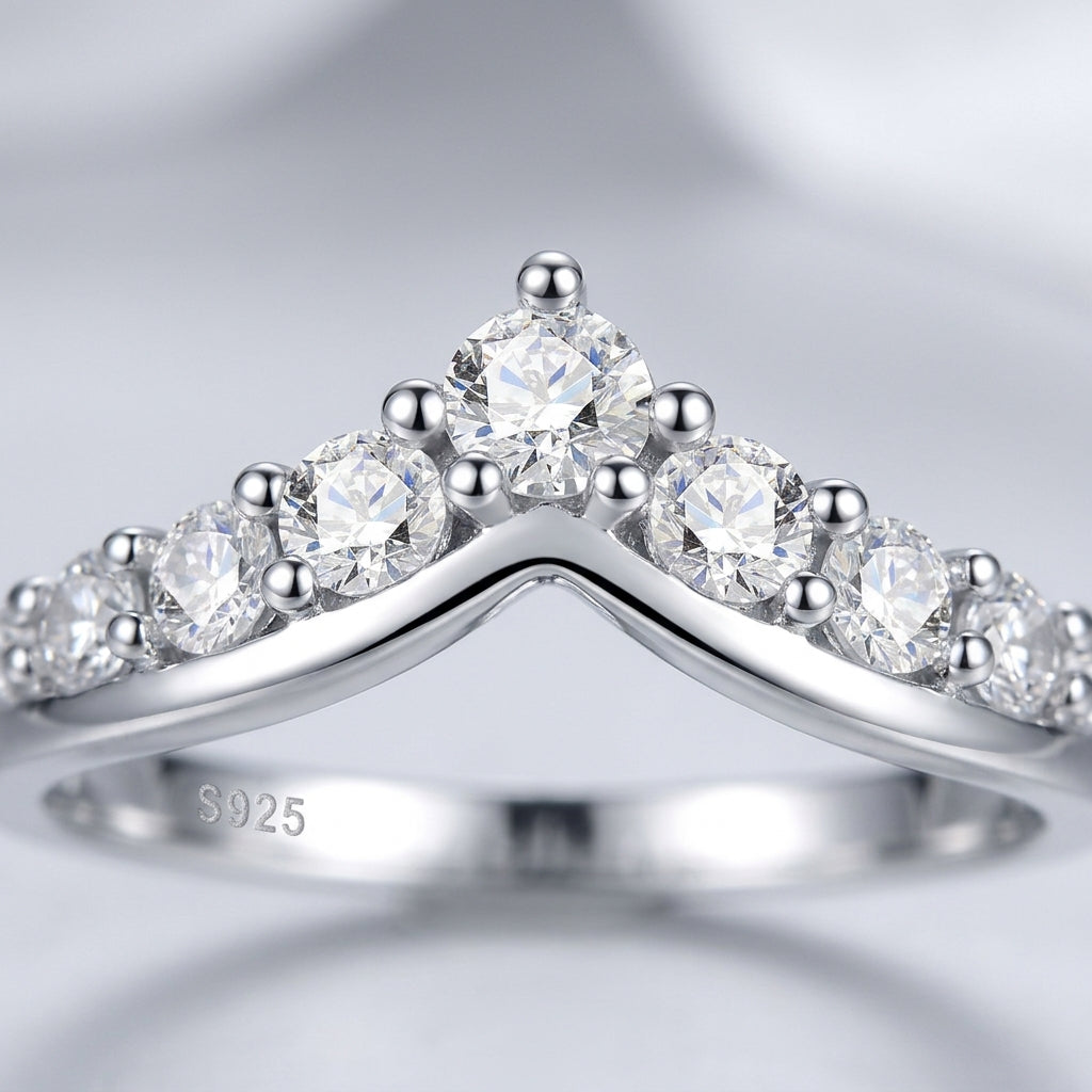 Close macro studio portrait of a luxury contour v shape moissanite guard ring showcasing the shared prong claw detail.