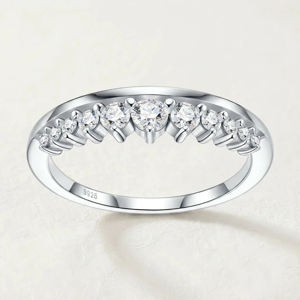 Symmetrical frontal studio portrait of a luxury contour v shape moissanite guard ring highlighting the curved tiara arch.