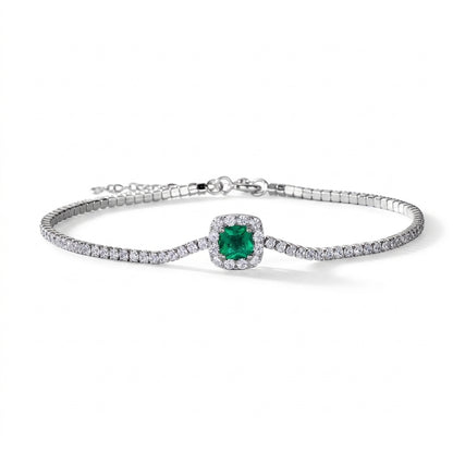 Flat lay studio product shot of a luxury cushion-cut lab-grown emerald tennis bracelet with a micro-pave halo.