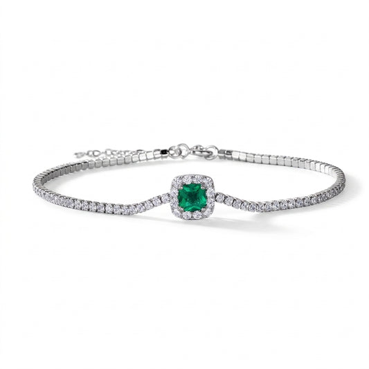 Flat lay studio product shot of a luxury cushion-cut lab-grown emerald tennis bracelet with a micro-pave halo.