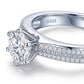 Micro macro profile focus on the double row pave band, six-prong head, and S925 hallmark of a luxury moissanite proposal ring.