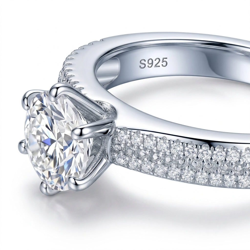 Micro macro profile focus on the double row pave band, six-prong head, and S925 hallmark of a luxury moissanite proposal ring.
