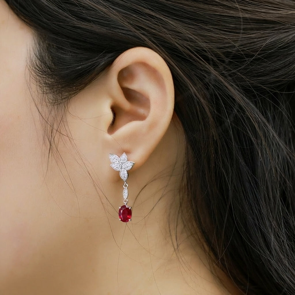 Side profile view of a model wearing the long linear drop side of classic ruby mismatched leaf earrings.