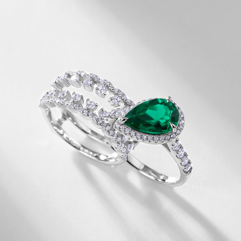 Side view of a premium luxury pear-cut emerald 2-piece stacking ring combo showcasing precise prong artistry.