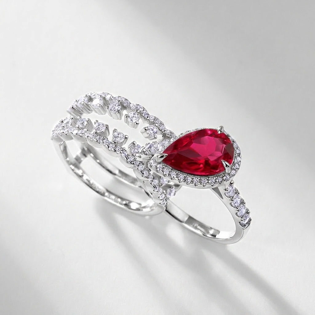 Side view of a premium luxury pear-cut ruby 2-piece stacking ring combo showcasing precise prong artistry.