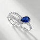 Side view of a premium luxury pear-cut blue sapphire 2-piece stacking ring combo showcasing precise prong artistry.