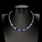 Front product view of a luxury square-cut blue sapphire statement necklace displayed on a premium black mannequin bust.