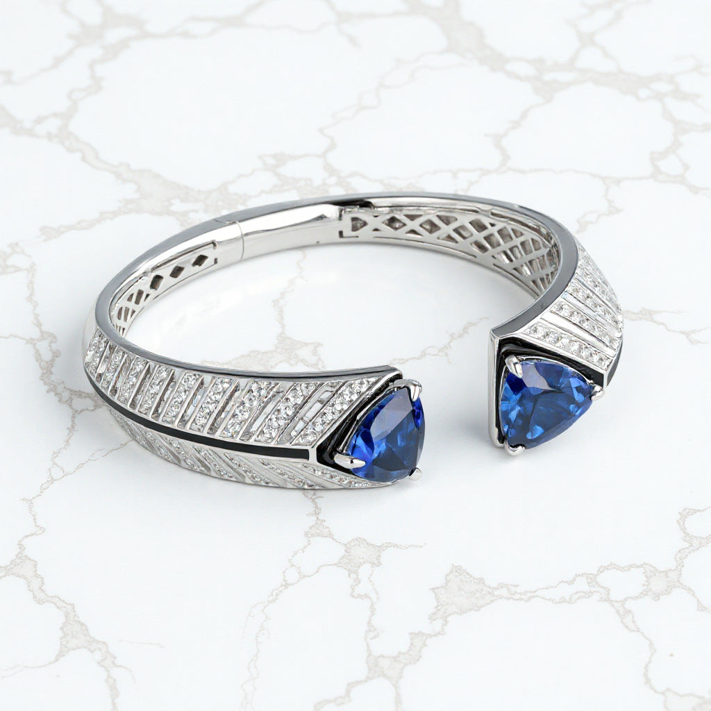 Silver ring with blue gemstones on a white lace background