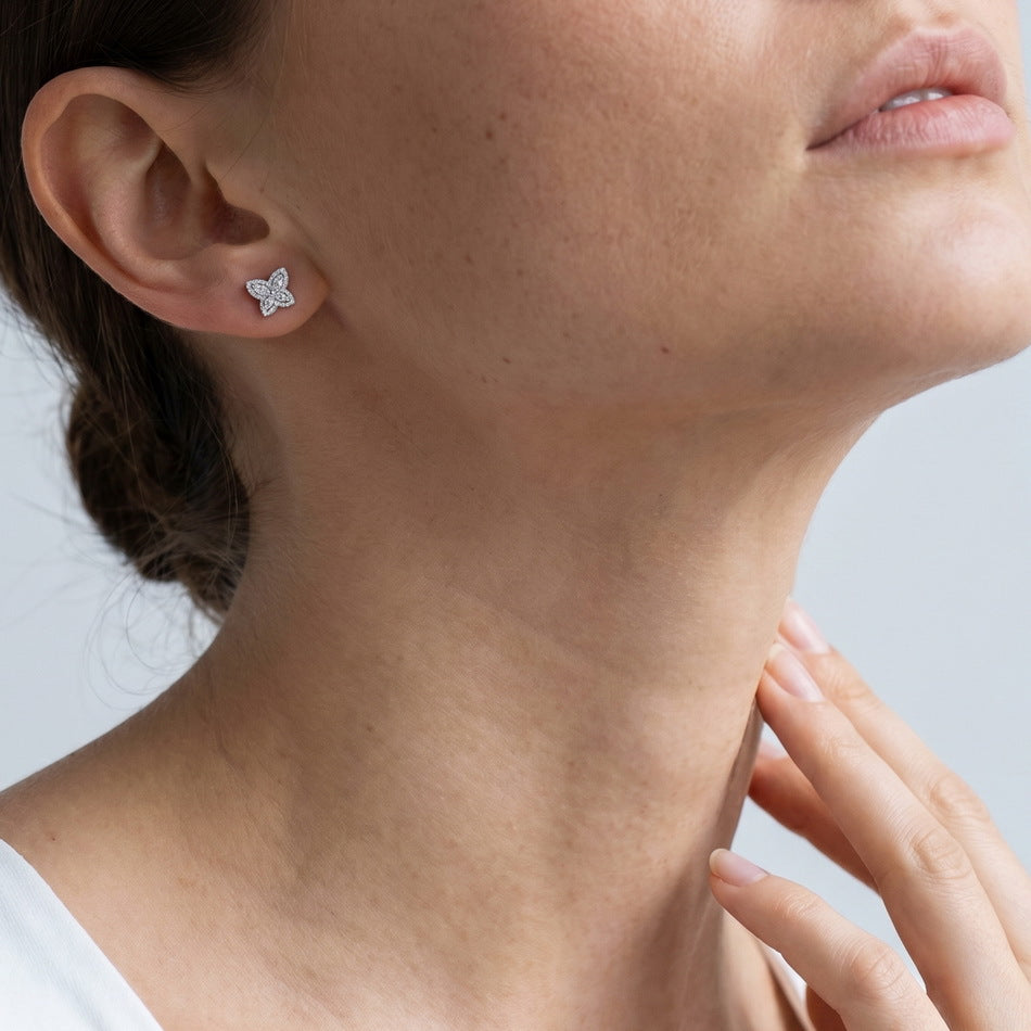 Model wearing lab grown diamond marquise butterfly halo stud earrings.