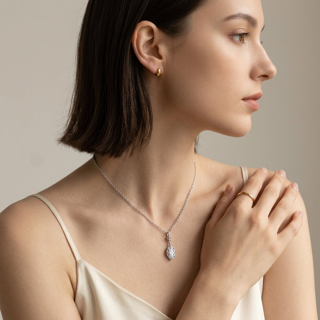 Model wearing modern marquise cut lab diamond bezel solitaire drop necklace.
