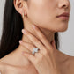 Close-up of a model wearing marquise cut moissanite three stone bridal set.