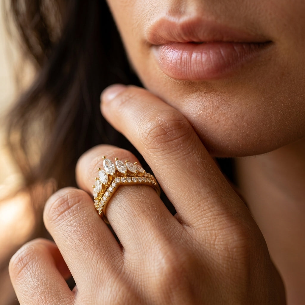 Model wearing gold marquise cut moissanite crown tiara stacking ring in a daylight shot.