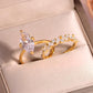 Angled shot of gold marquise solitaire and crown stacking ring set in jewelry box.