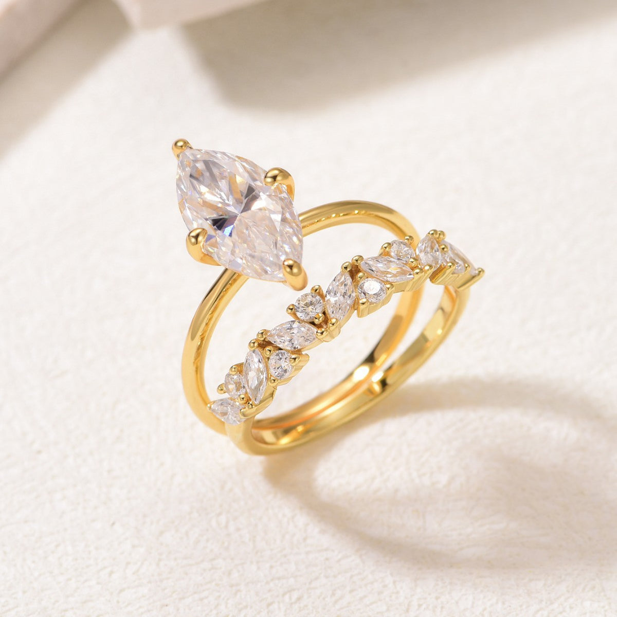 Perspective view of marquise moissanite solitaire and crown stacking band.