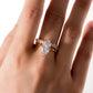 Model wearing marquise cut moissanite solitaire nested with crown stacking band.