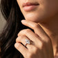 Close-up view of a model wearing marquise cut moissanite engagement ring with multi-row pave band.