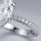Macro view of double-row micro pave moissanites set along the ring band and base undergallery.