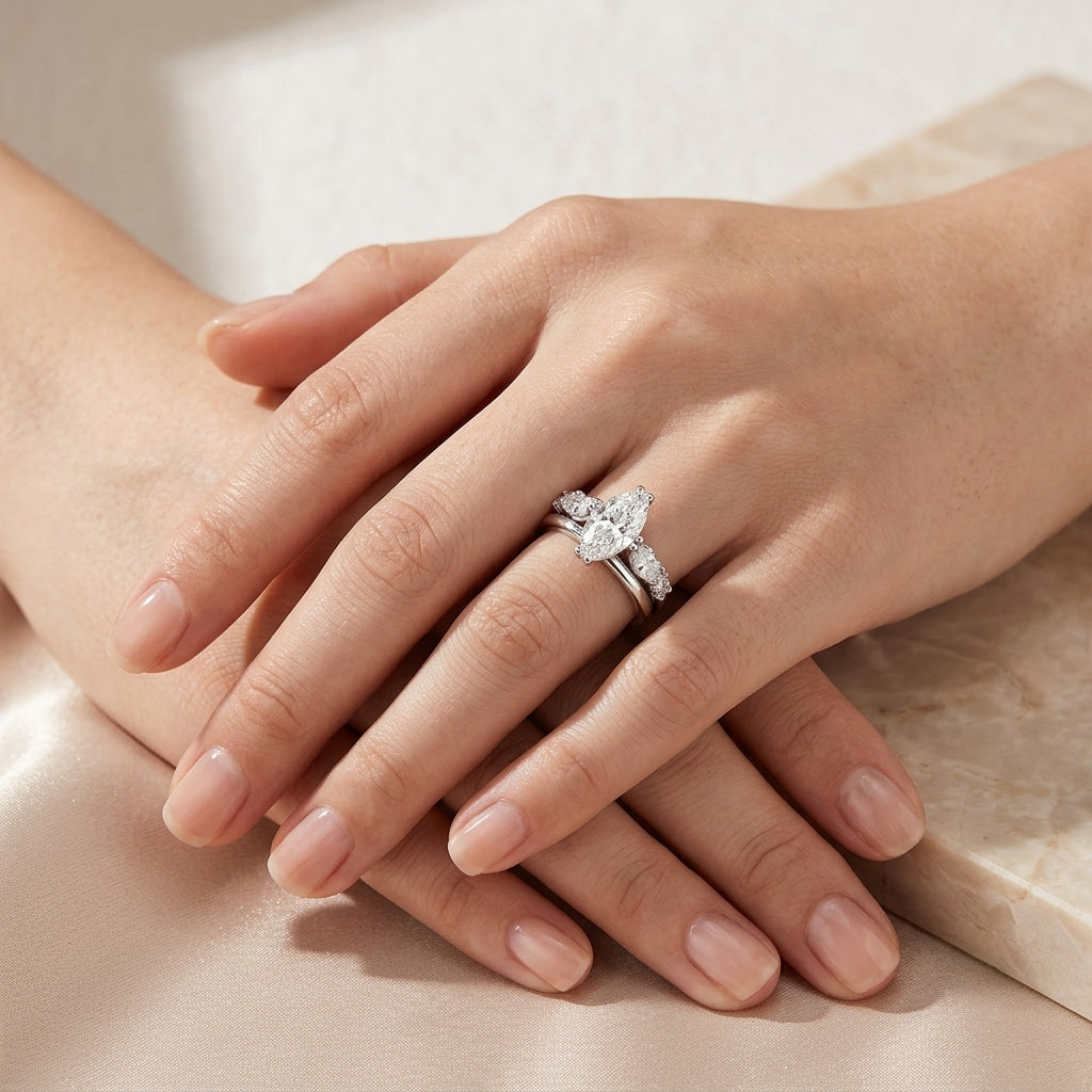Model showing marquise cut moissanite three stone bridal ring set on hand.