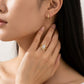 Model wearing marquise cut moissanite solitaire ring nested with wishbone chevron stacking band.