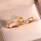 Angled shot of gold marquise solitaire and wishbone chevron stacking ring set in jewelry box.